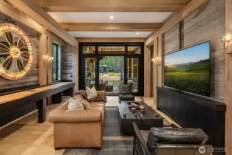 Walls are solid wood. Wyoming Snow Fence, and White oak wainscot with black  lacquer finish. Large hidden doors tuck behind the 85” TV, to allow for closing the room  off for privacy and sound.