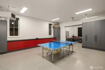 3 car garage with Epoxy floor, Amazing custom cabinets, including 3” thick solid white oak butcherblock counter with black lacquer finish. Reznor heater on independent thermostat to keep garage warm in the winter.  Super bright LED lighting High garage door tracks and wall mount openers to keep the ceiling high and tidy, this  also allows for a car lift which electrical is roughed in for. Electric car charging is ready to go.  All walls, windows, and doors in garage are fully finished and painted.  Garage overhead doors are insulated 3” thick, custom made with insulated glass.