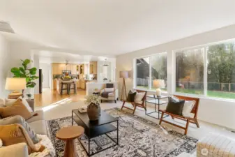Spacious living area showcasing flexible seating and seamless flow into dining and kitchen spaces.