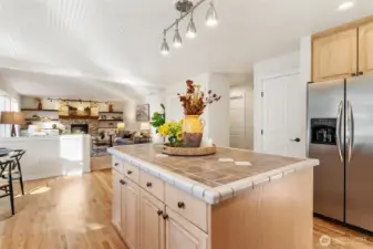 Wide kitchen view highlighting open layout and connection to dining and living areas.