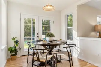Sun-filled breakfast nook overlooking the backyard, offering a charming space for casual meals.