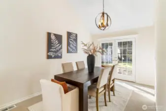 Formal dining room with statement lighting and elegant finishes, perfect for hosting guests.