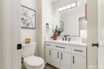 Well-placed lower-level half bath enhances the flexibility of the downstairs area.