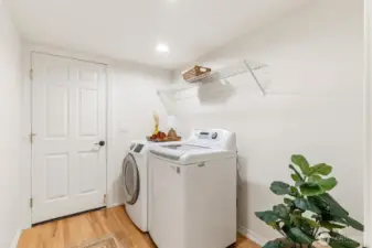 Dedicated laundry room with storage and functional layout.