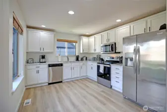 Sun-filled and thoughtfully designed, this kitchen invites everything from quiet morning coffee to lively dinners with friends. Easy access to the backyard extends the living space outdoors, making entertaining and summer gatherings effortless.