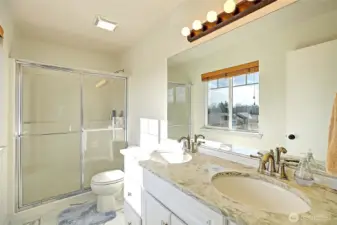 The attached ¾ bath features a spacious walk-in shower, dual-sink vanity, and bright natural light. Crisp finishes and a functional layout create a refreshing, comfortable space to start and end your day.