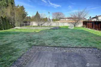 The backyard is designed for everyday enjoyment with a level lawn, patio area, and ample space for entertaining or play. A private, versatile outdoor space ready for gatherings, gardening, or quiet evenings at home.