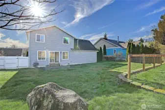 This inviting backyard offers a peaceful setting with open green space and a patio just off the home—perfect for barbecues, playtime, or quiet moments in the sunshine. A wonderful outdoor retreat that truly completes the home.