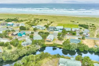 Aerial view showcasing the tranquil canal and surrounding beachside neighborhood.