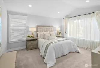 Relax after a long day in the large primary suite featuring a vaulted ceiling, en-suite bathroom and walk-in closet