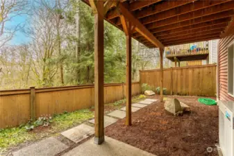 View of low maintenance patio and backyard from slider