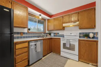 Kitchen w Window Overlooking Backyard & Deck, Oak Cabinets and Food Pantry.