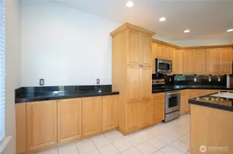 Additional dining space featuring convenient built-in cabinetry and extended countertops for added functionality and style.