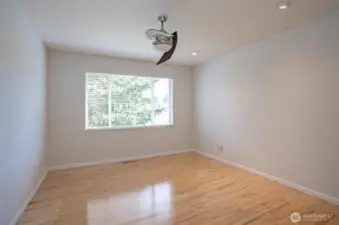 Spacious primary suite featuring radiant hardwood floors that add warmth and elegance.