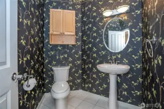 Generously sized main-floor powder room offering style and convenience.