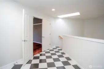 Spacious upper landing with double-door entry leading to the media room, complete with pre-installed theater wiring for an immersive entertainment experience.