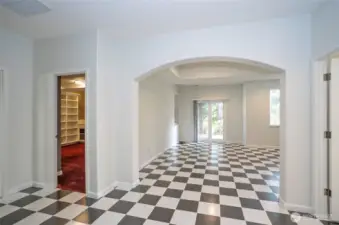 Lower-level landing opens to a spacious family room on the right, while a versatile craft room or office space on the left adapts to suit your needs.