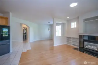 Another stunning view of the spacious, light-filled living and dining areas, where the seamless transition from ceramic tile to hardwood flooring enhances the home's elegant flow.