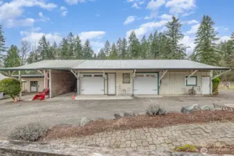 The custom Garage with 0ne 2 car carpeted show space with 1/2 bath. 3-4 car workshop garage, Large truck/boat carport & workspace with high capacity vechicle lift.