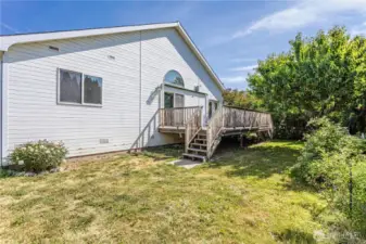 Backyard and deck with mature fruit trees