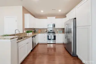 Built-in pantry on right side has deep upper and lower cabinets.