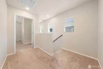 The pop of windows outline the stairway for extra light and the primary bedroom is located just at the top of the stairs.