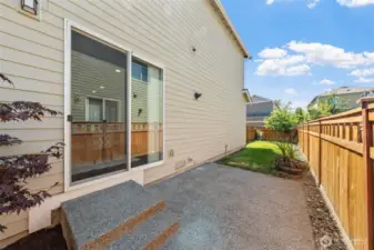 The back patio with concrete slab is perfect for your outdoor grill.