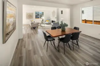 The dining room area looking back into the living room and kitchen