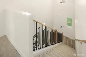 Lovely metal staircase railings and plush new carpeting throughout the upstairs