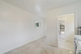 View from utility room to exterior door and kitchen.