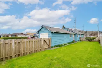 View from the backyard of garage and back side of home.