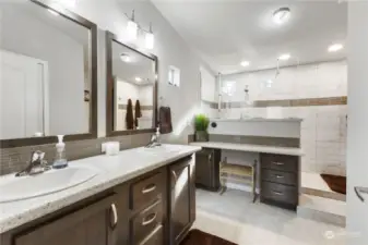 Primary bathroom is oversized. To the right of the shower is even more cabinetry. There is no lack of storage!