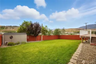 Fully fenced back yard. Automatic sprinklers & garden shed