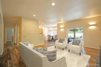 Virtually stage living room features new floors throughout the home.