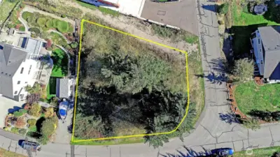 Water & power on the NW corner. Property lines highlighted for reference.  Usable land surrounded by established homes and paved access on two sides.