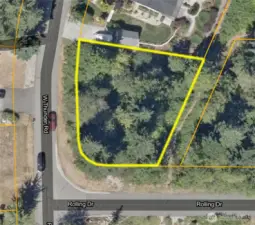 Property lines highlighted for reference.  Usable land surrounded by established homes and paved access on two sides.