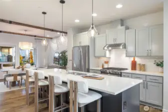 Oversized island makes food prep and dining seamless.