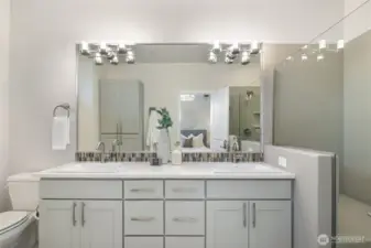 Ensuite primary bath with ample storage and tasteful colors.