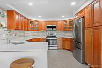 Brand new kitchen with quartz countertops and stainless steel appliances.