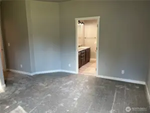 Primary bedroom looking into primary bath.