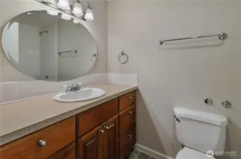 Main bath has freshly tiled vanity backsplash and new shower to go with an oversized tub.