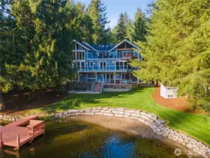 Coveted Lake Marcel Custom Waterfront Home with 135' of Waterfront & Bay Living. Professionally Designed terraced rockery wall for entertaining.