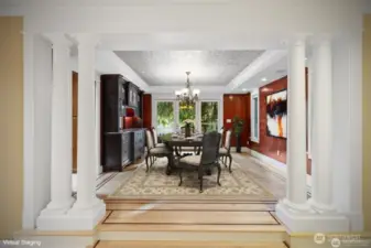 Formal Entertaining Dining Room with Specialty Crafted built-in display cabinets and convenient pass through serving window. Beautiful Venetian Plaster walls accented with Traditional 1875 Style Stamped Tin Ceiling.