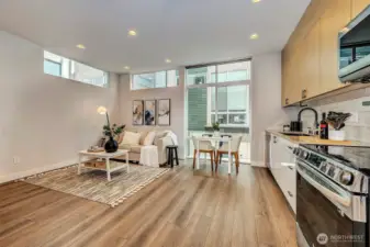 Expansive windows invite abundant natural light, while custom shade blinds throughout offer enhanced comfort and privacy.