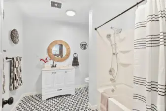 Large updated bathroom with linen and towel storage.
