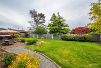 EXPANSIVE AND FULLY FENCED BACKYARD IS PRIVATE AND LANDSCAPED