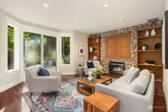 View from the kitchen to the family room. The propane fireplace has a custom, river rock surround
