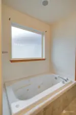 Jetted tub in primary bedroom bath