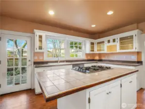 The door opens to a patio area and fully fenced backyard. Pathway to the two-car garage.