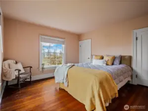 Primary bedroom with double closets, original fir floors, and fantastic views.